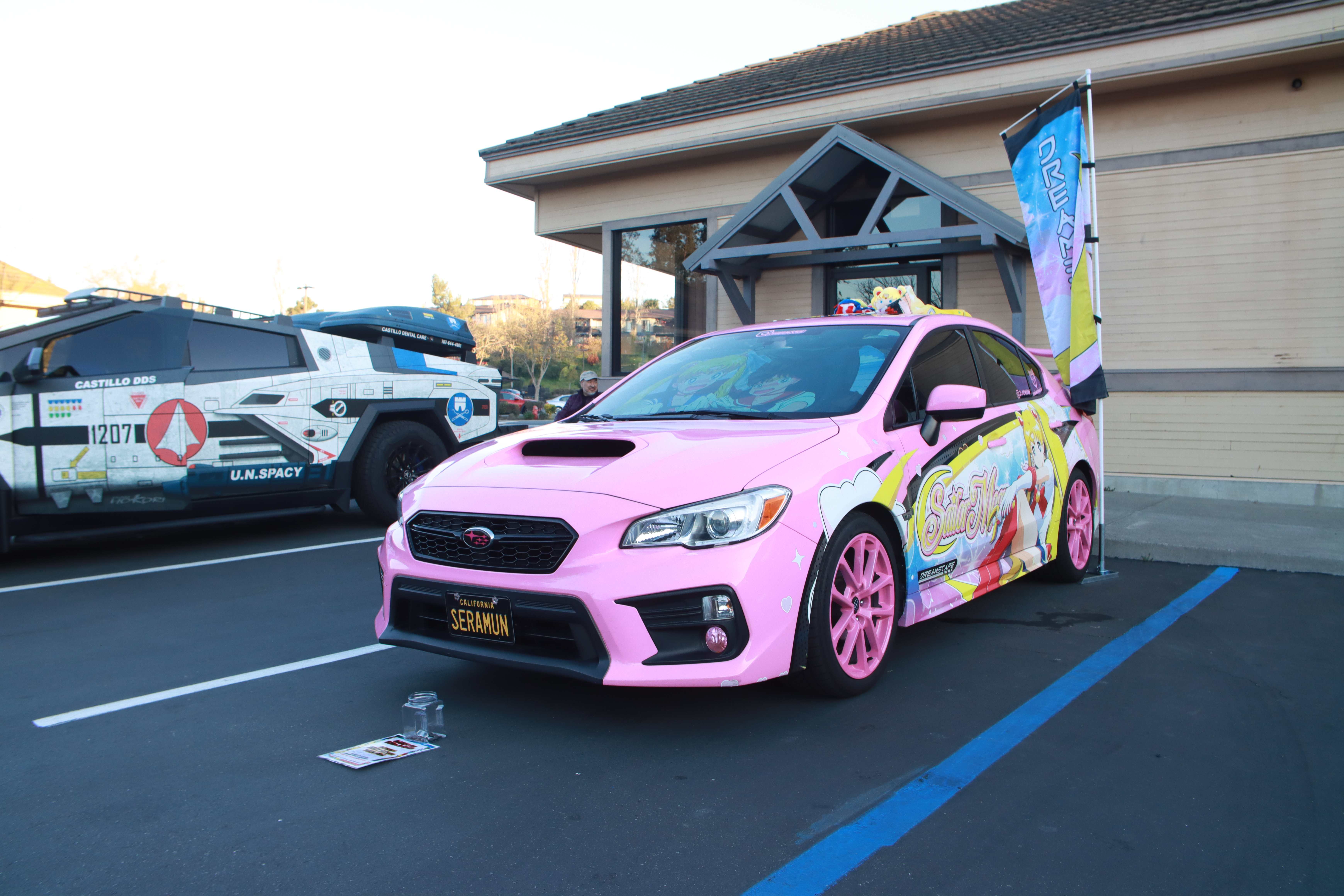 Gray Chevelle SS muscle car with white racing stripes and hood open