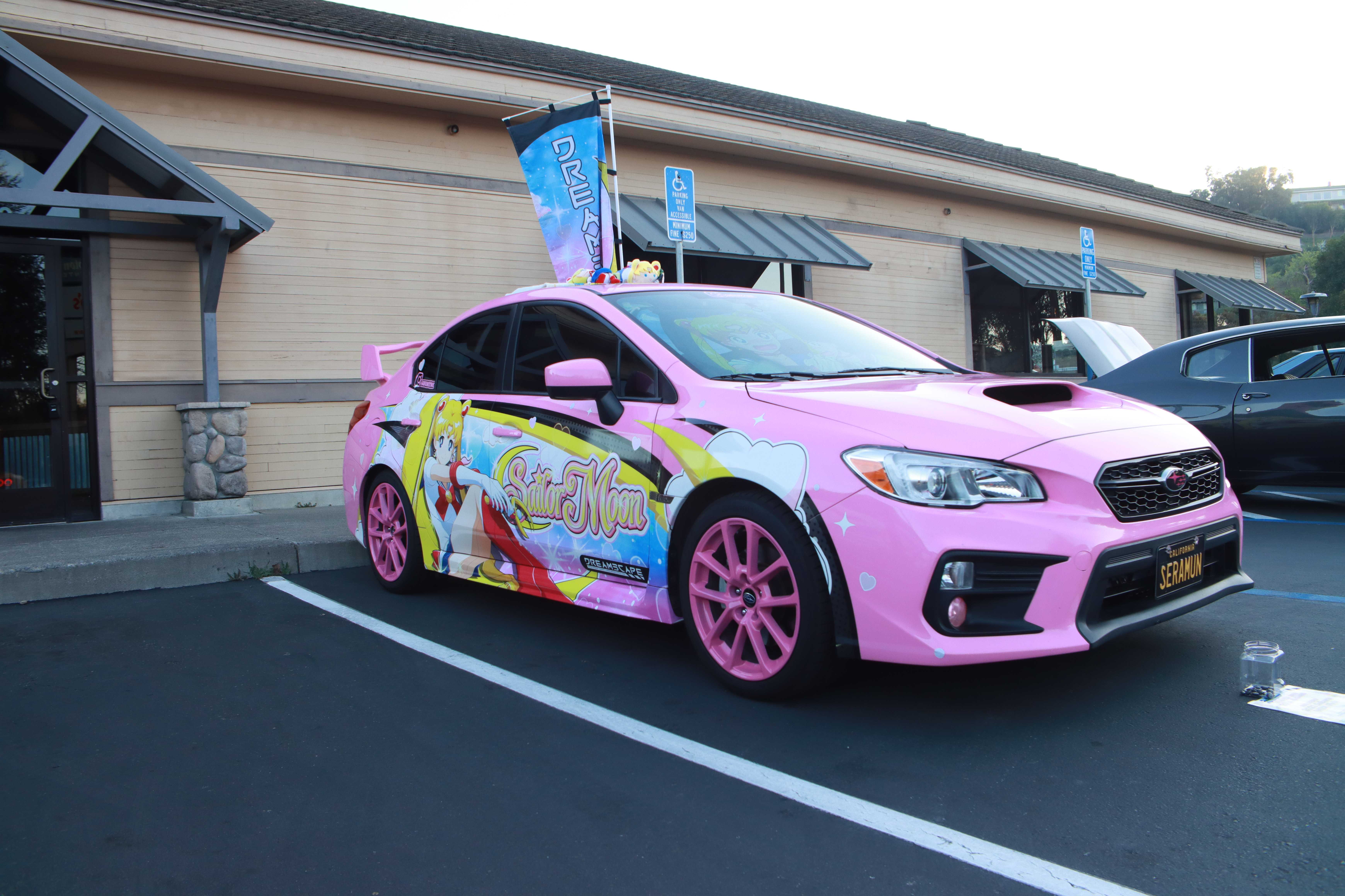 Light blue classic Ford Mustang with hood open showcasing engine bay