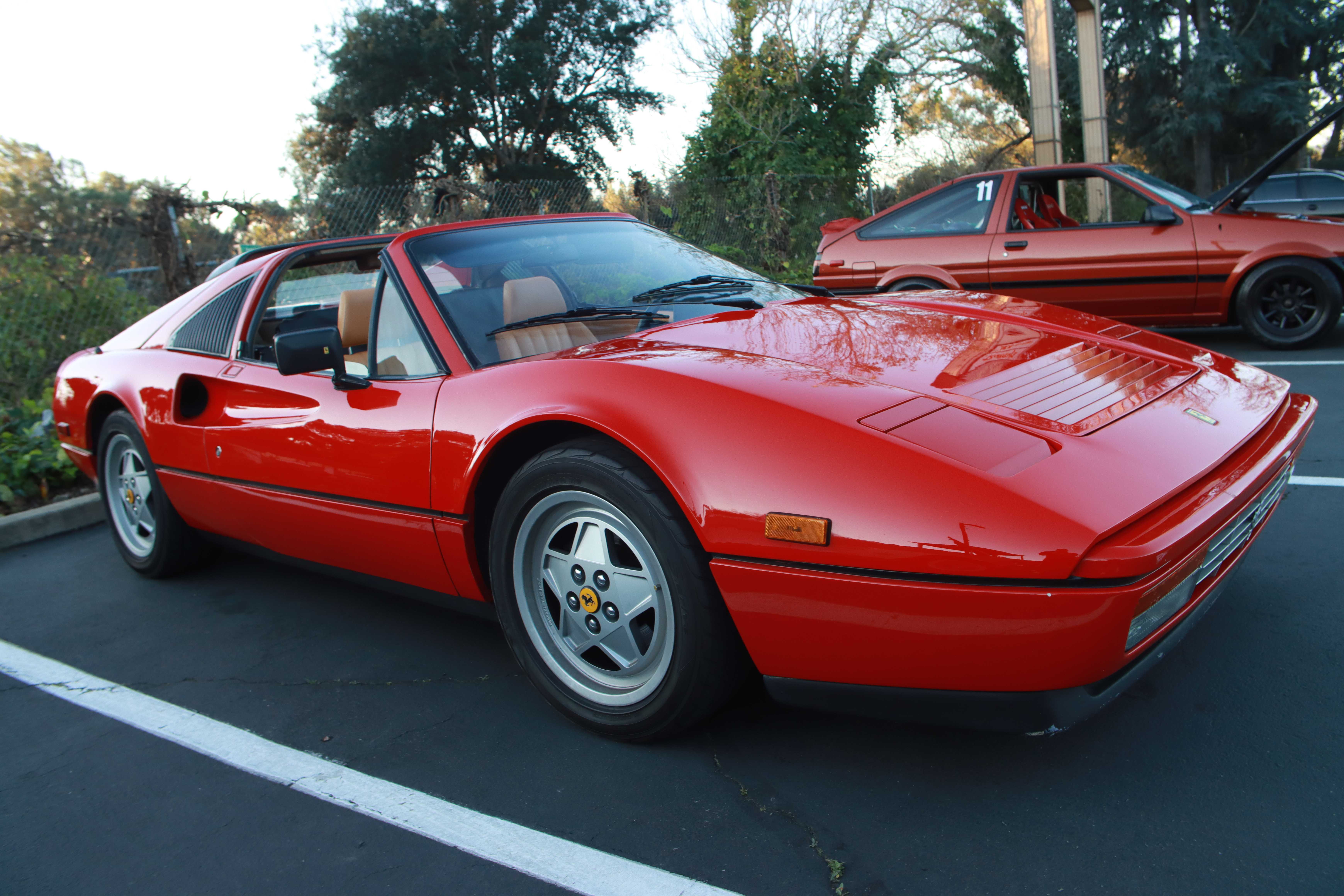 Red Ferrari 328 GTS with targa top and scenic background
