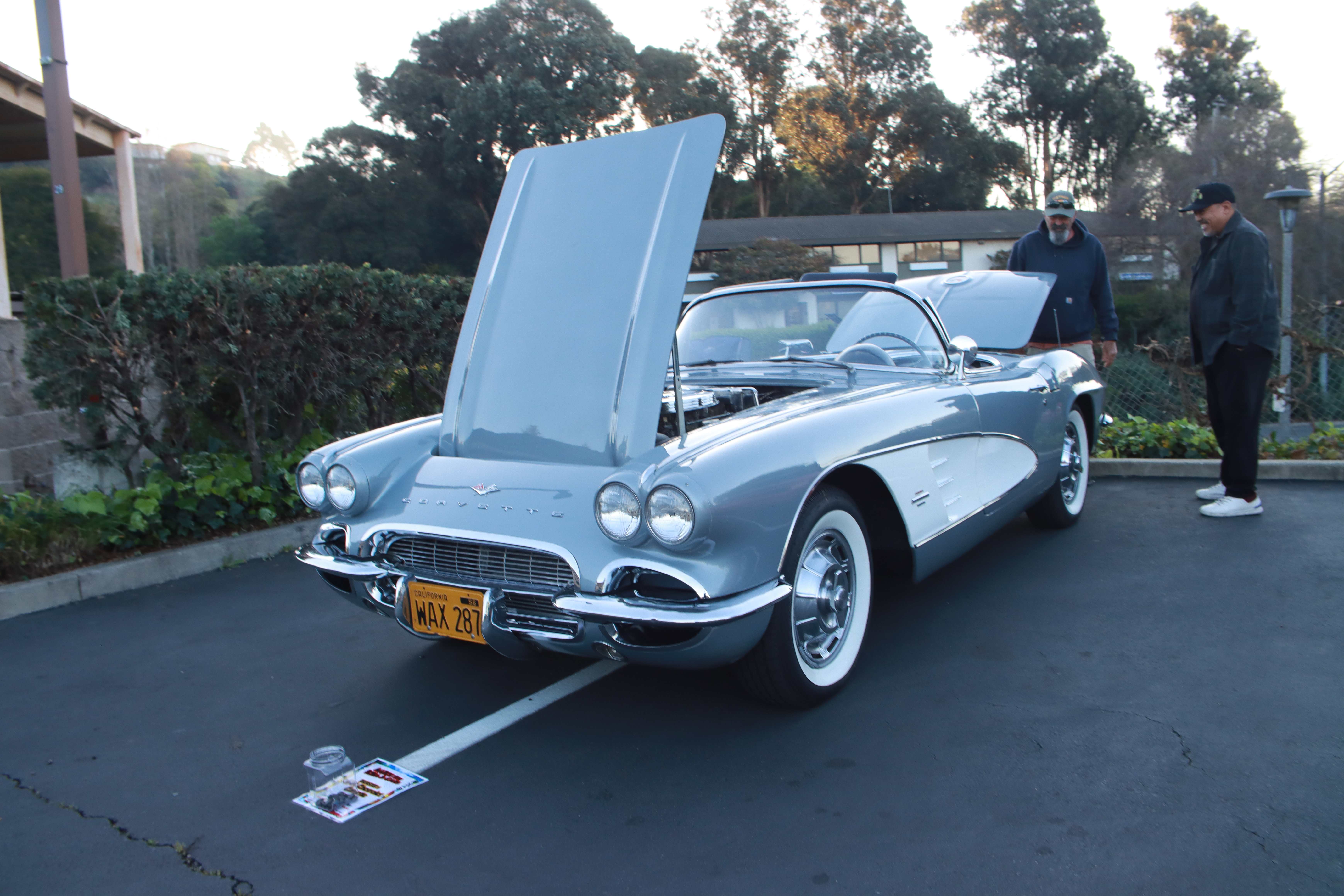 Red Ferrari 328 GTS front view with voting jar visible on ground