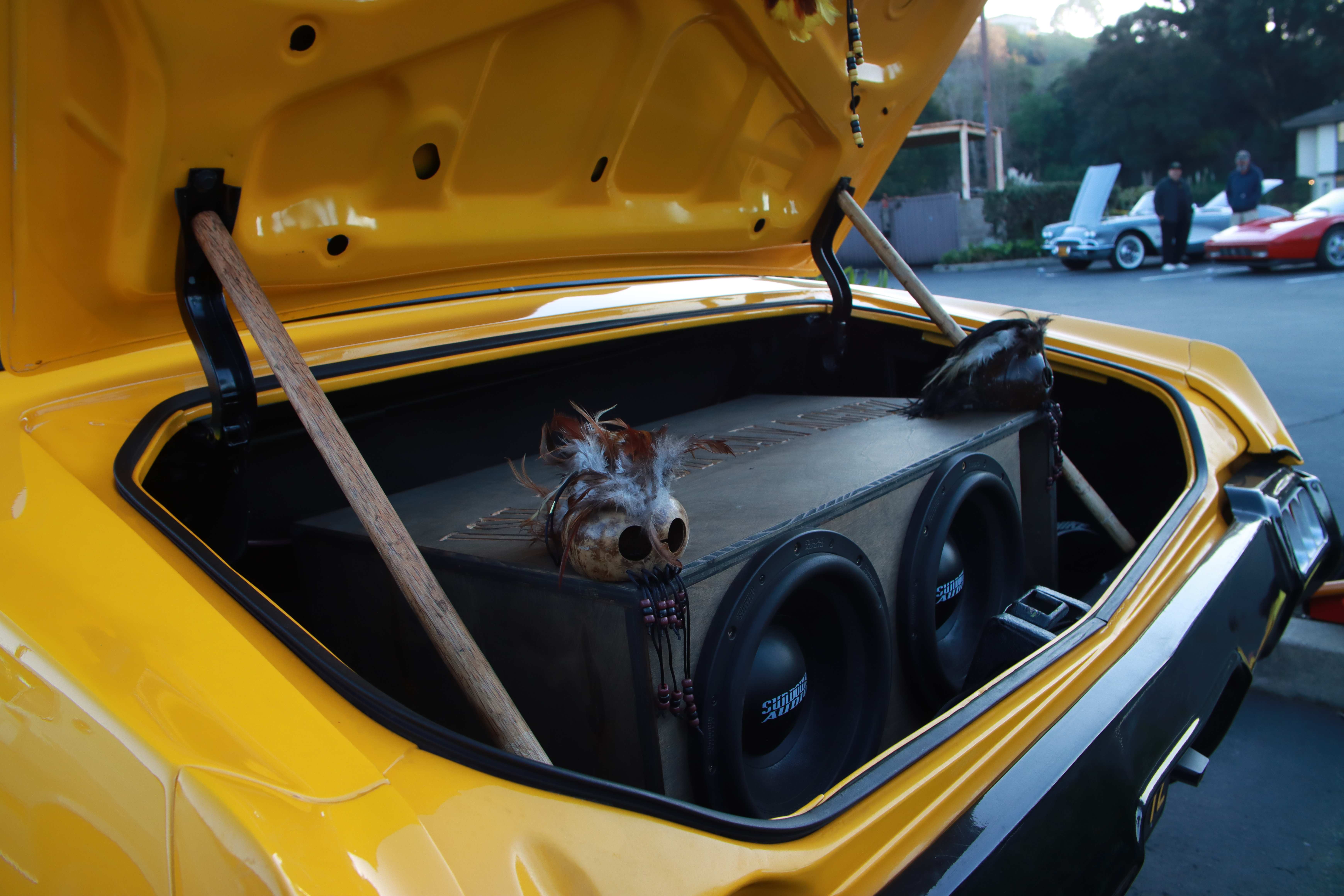 Light blue classic Ford Mustang front three-quarter view with tiki decoration