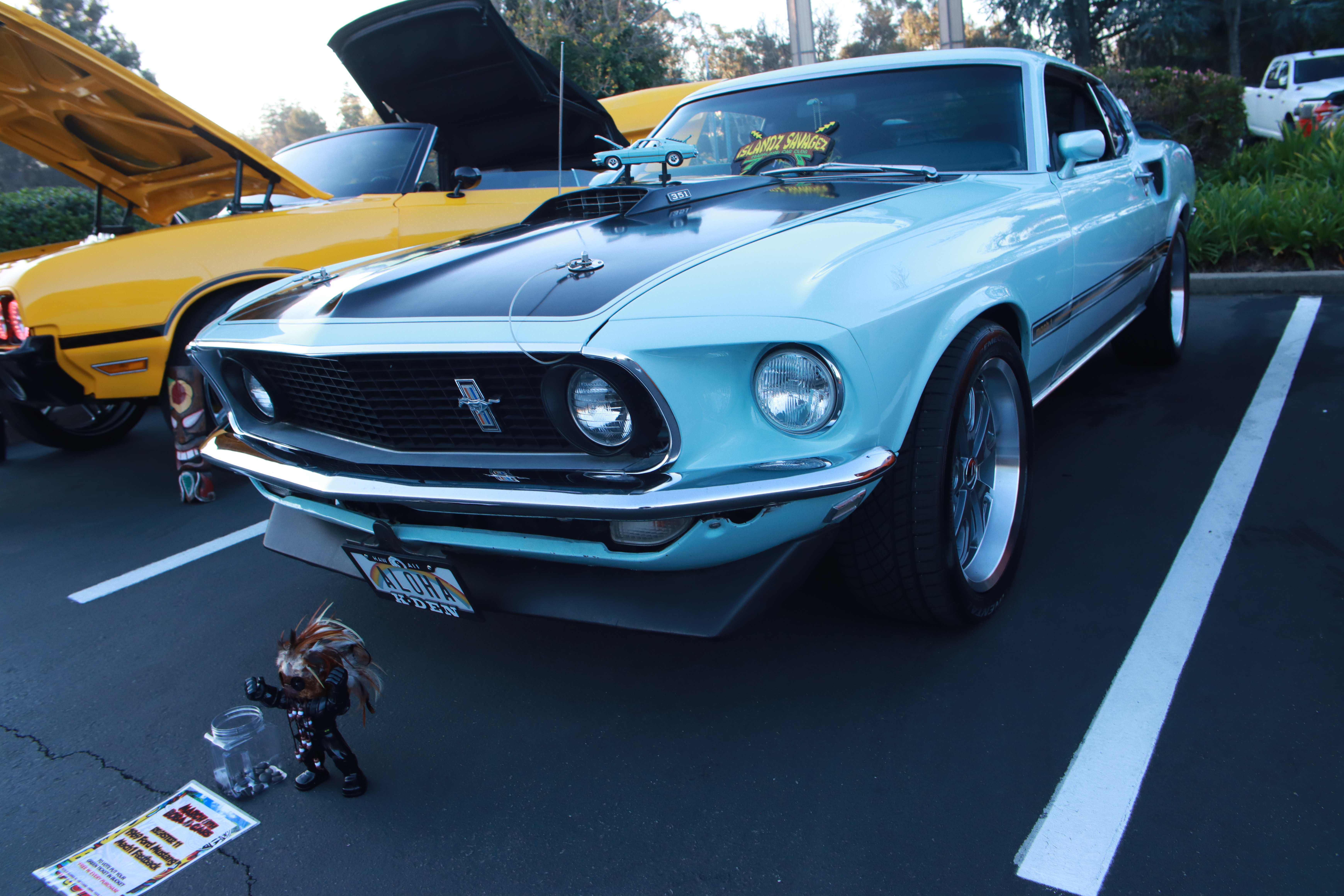 Red Toyota AE86 Corolla Trueno front view with hood open and voting materials